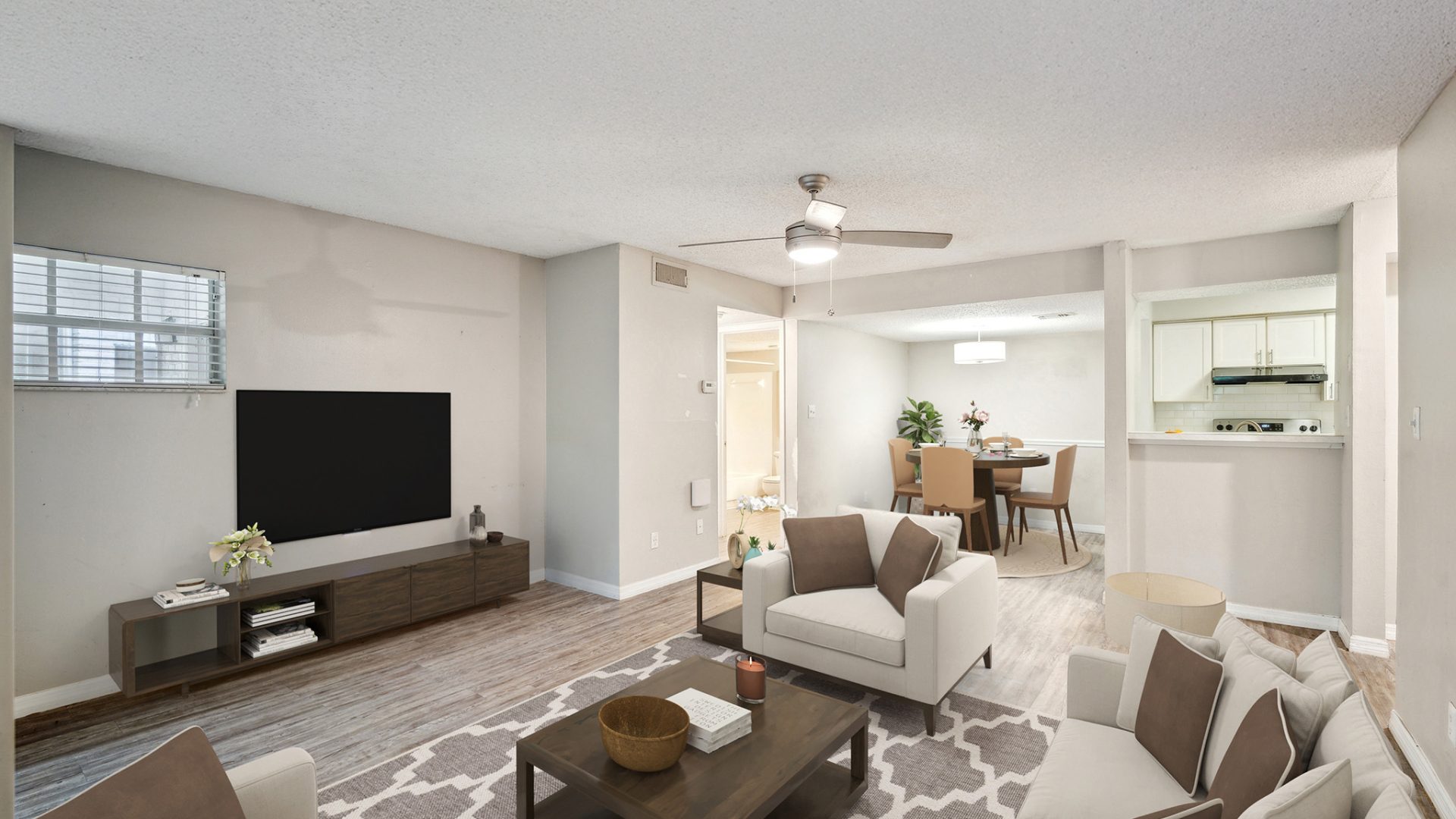 a living room with a flat screen television and a couch at The  Brady at Tampa Palms