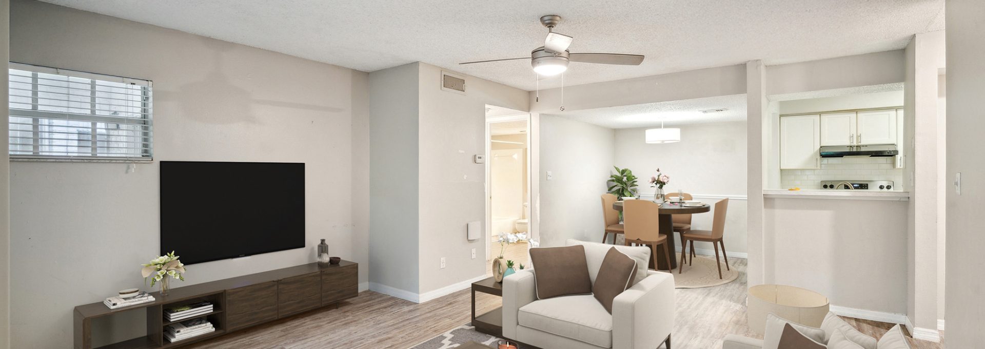 a living room with a flat screen television and a couch at The  Brady at Tampa Palms