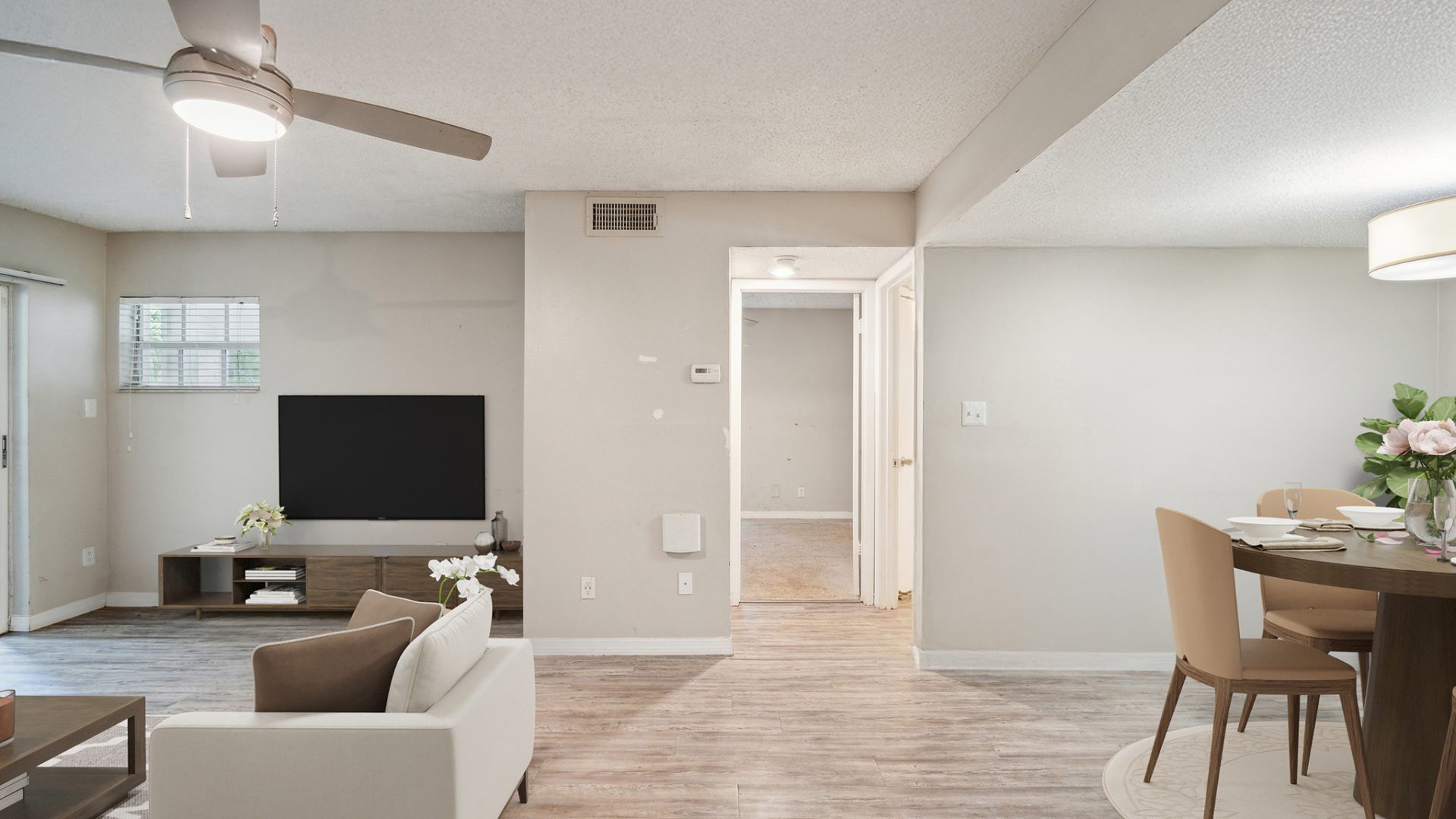 a living room and dining area with a ceiling fan at The  Brady at Tampa Palms